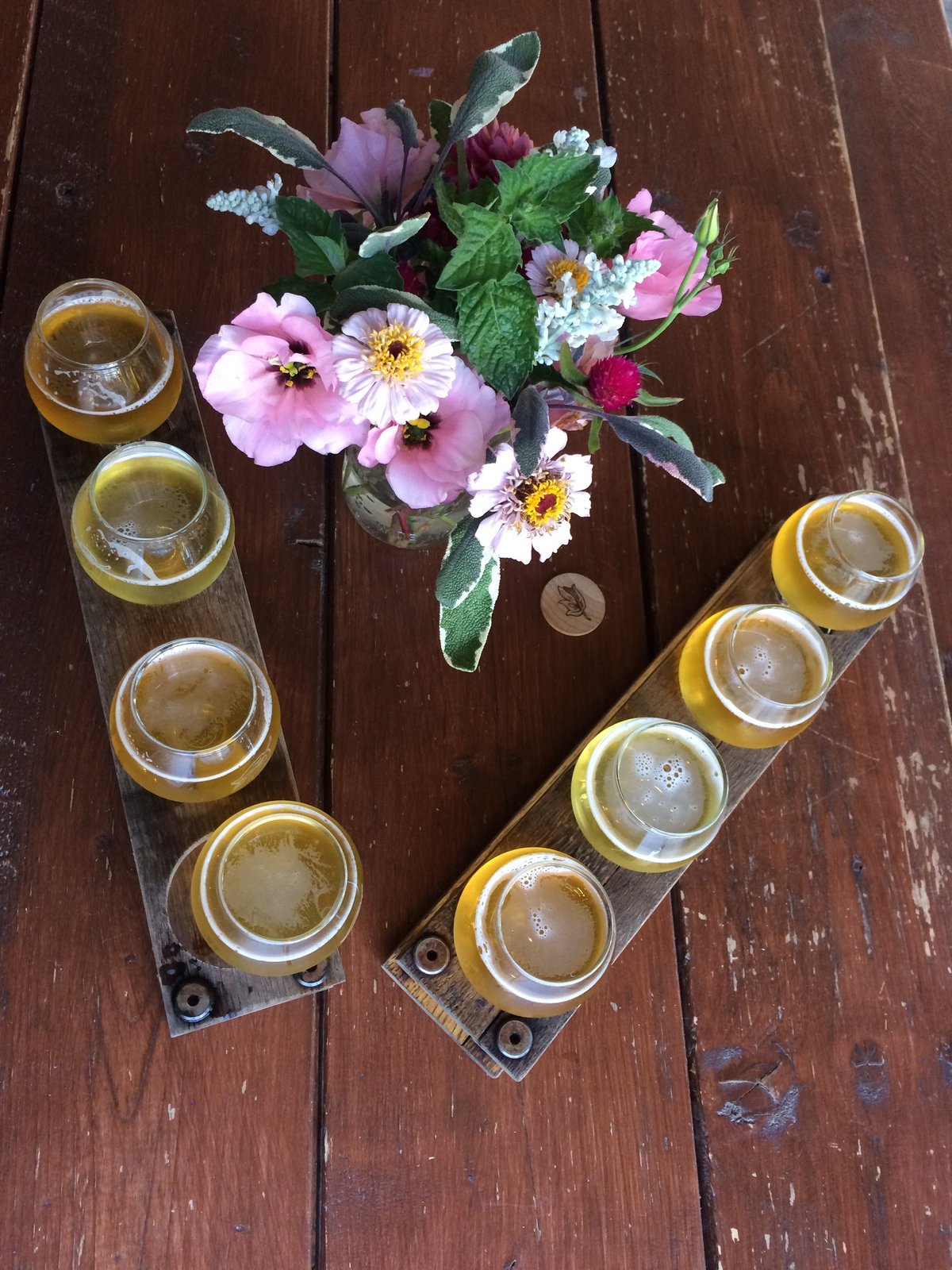 A flight of craft beers on a tasting board