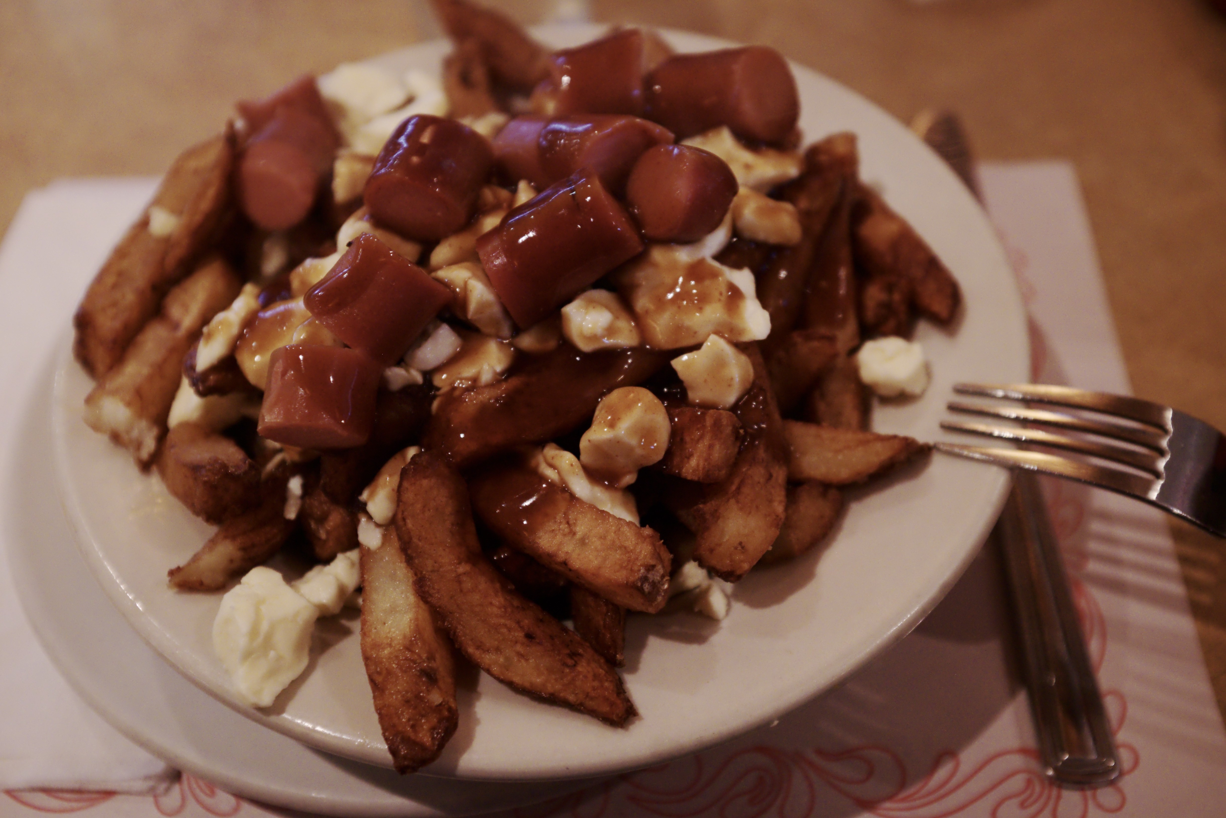 A plate of poutine with gravy and cheese curds (Montreal, 2017)