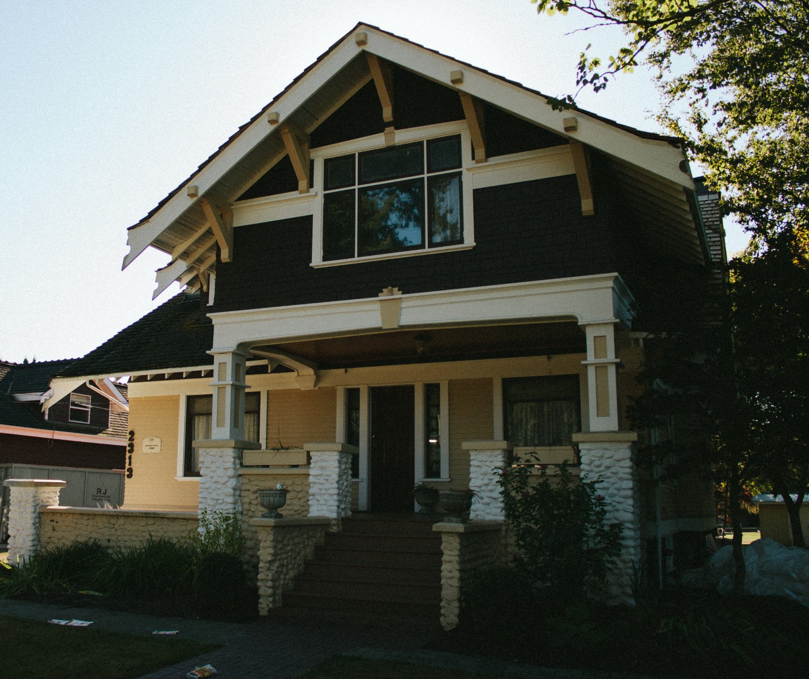 The front porch of Trethewey House, a Craftsman heritage home (the number 2313 is visible on the porch pillar)