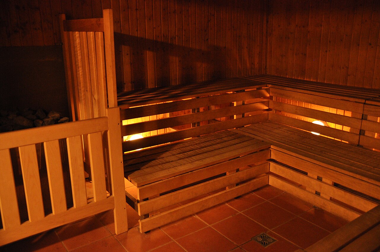 A Finnish sauna with wooden benches inside a wellness spa.