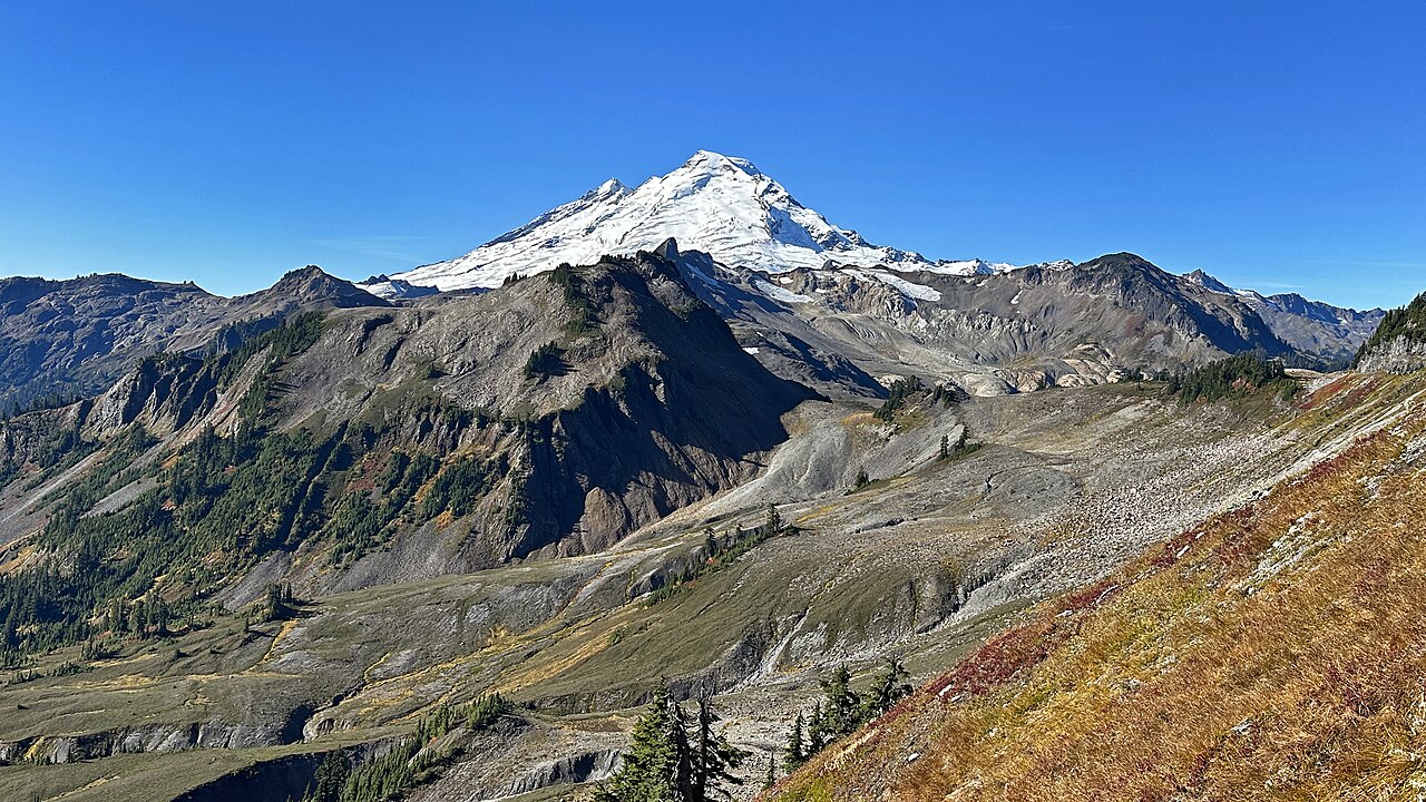A mountain peak rising above forest slopes