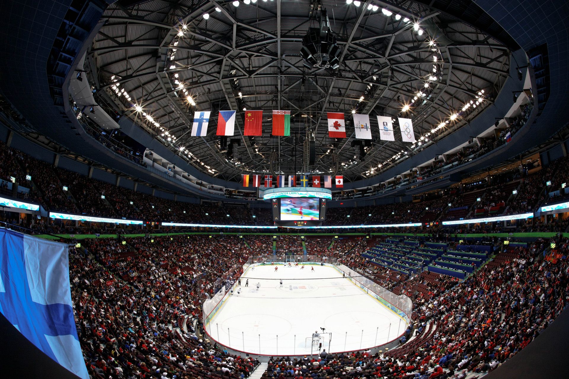 Inside the arena before puck drop, ice lit and seats filling up